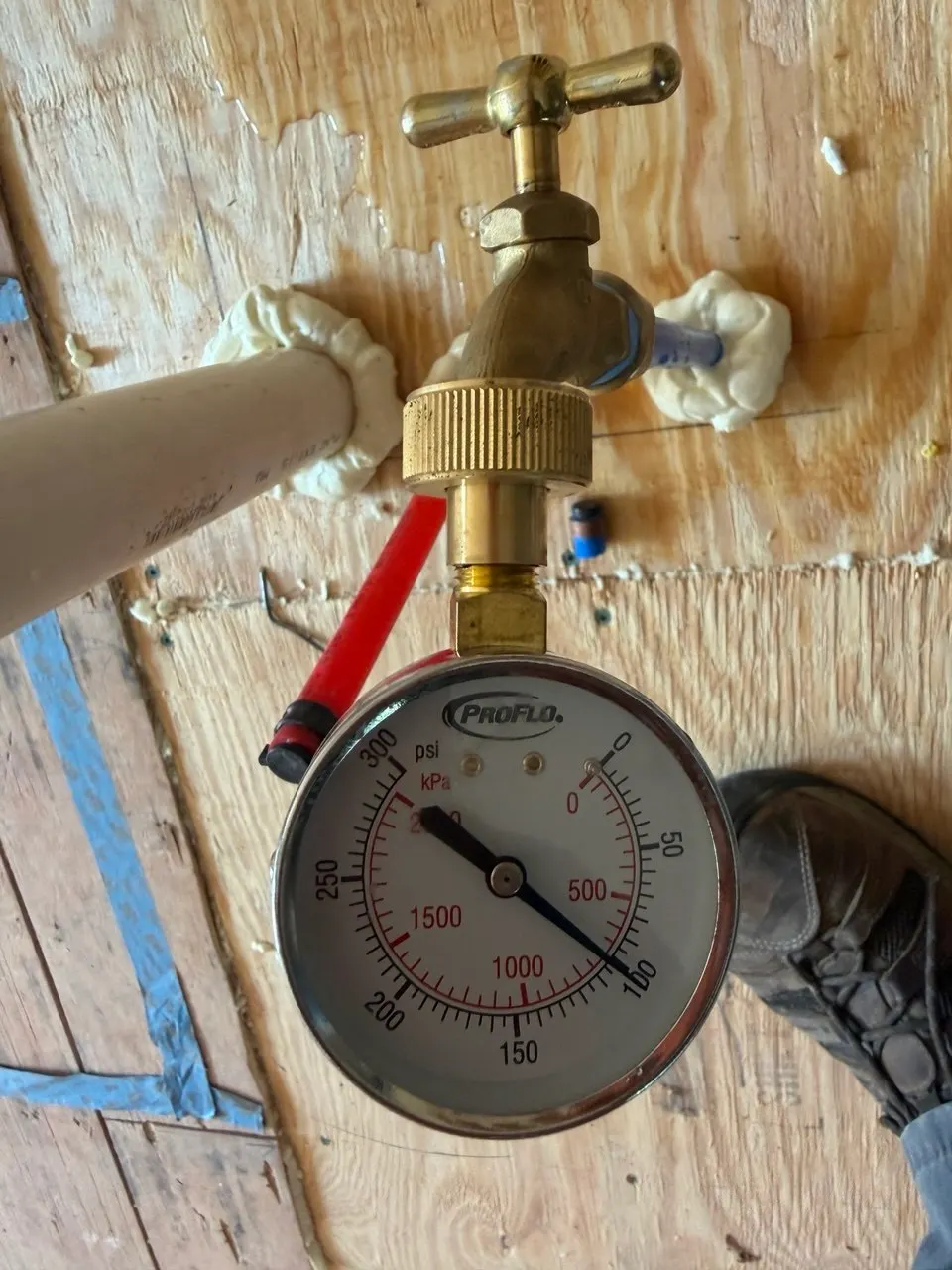 Pressure gauge attached to the island water supply stub-out during leak testing