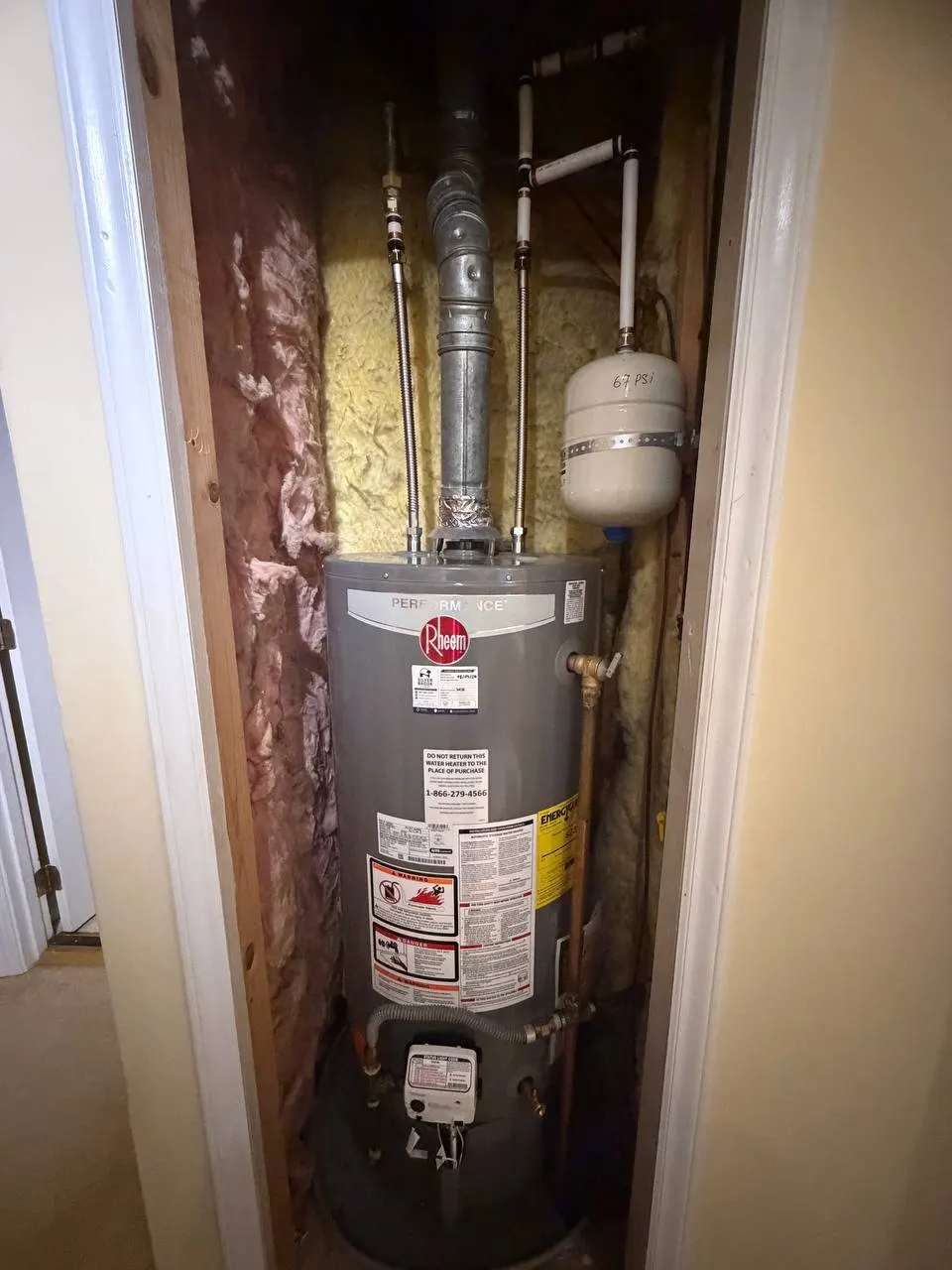 New gas water heater in a closet with flexible stainless connectors, flue pipe and a strapped thermal expansion tank